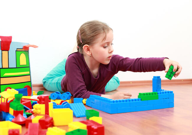 Adorable girl playing with blocks