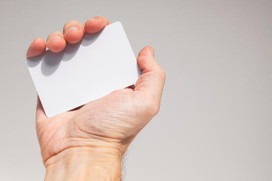 Male hand holds white empty card