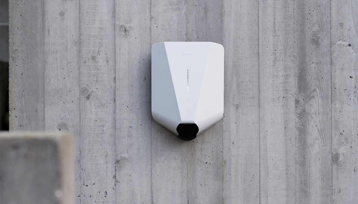 White Easee charger mounted on concrete wall