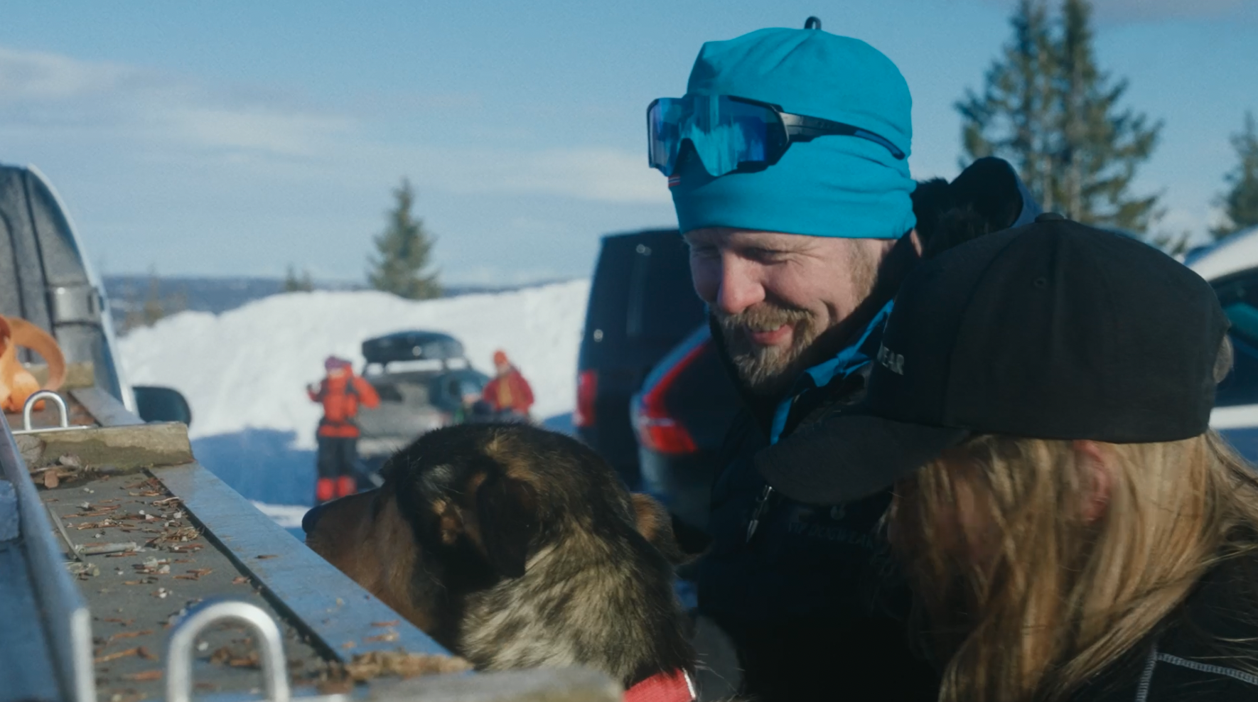 Personer som gjør klar hunder for hundekjøring