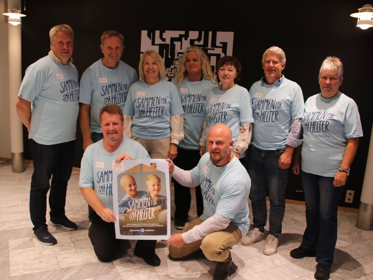 En gruppe mennesker i TV-aksjonen t-skjorter som holder en plakat med budskap om å støtte tv-aksjonen.