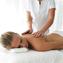 Young woman having back massaged