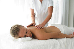 Young woman having back massaged